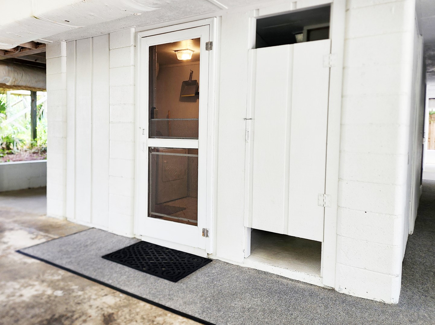 Laundry Room and Enclosed Shower in Carport